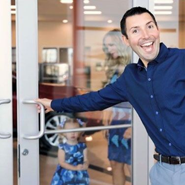 Smiling Guy opening door whilst small child looks out